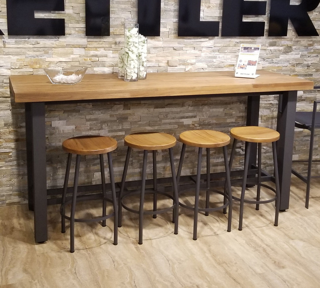 Canada Bar Height Dining Set with teak tops and durable black metal frame against stone wall background
