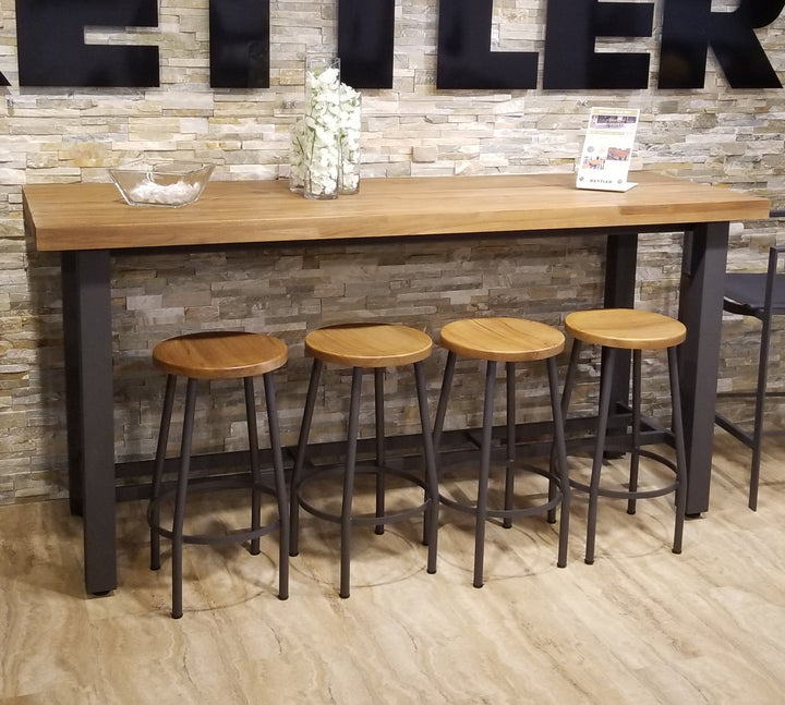 Canada Bar Height Dining Set with teak tops and durable black metal frame against stone wall background