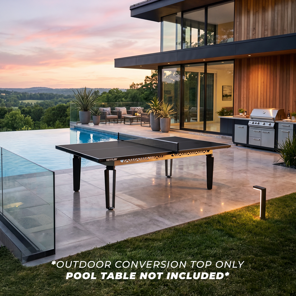 KETTLER Outdoor Conversion Top shown on a poolside table tennis table beside a modern home at sunset