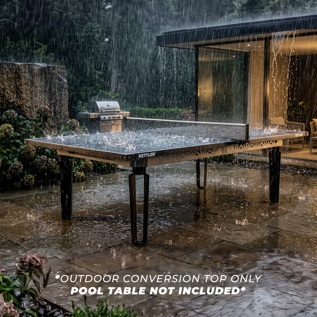 KETTLER Outdoor Conversion Top covering a pool table on a rainy patio beside a modern home