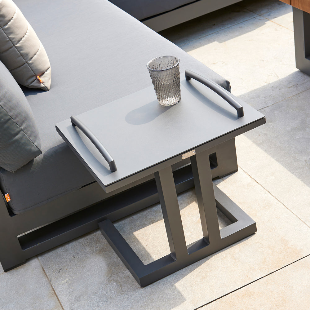 Easy Side Table in lava color with removable tray top and sturdy aluminum frame beside outdoor lounger