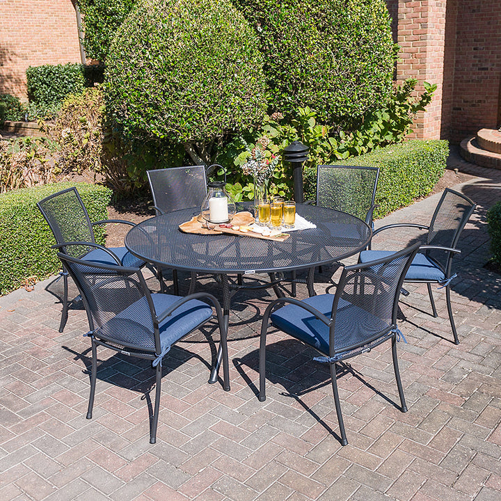 60-inch Round Mesh Top Table with iron grey electrotherm coating and six chairs, set on outdoor patio brick flooring.