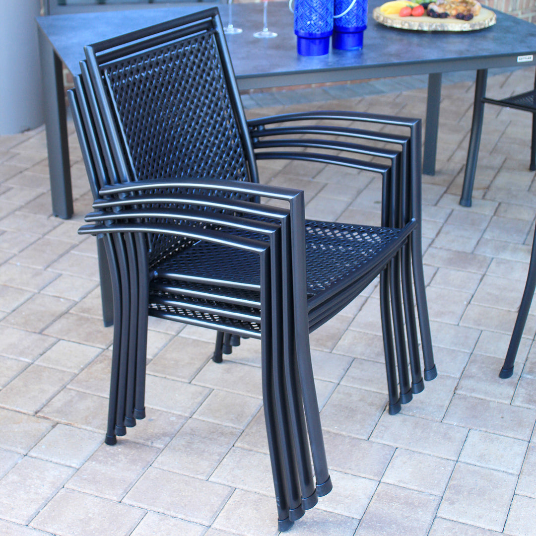 Reno 7-Piece Dining Set showing stackable wrought iron chairs with ergonomic design and black finish.