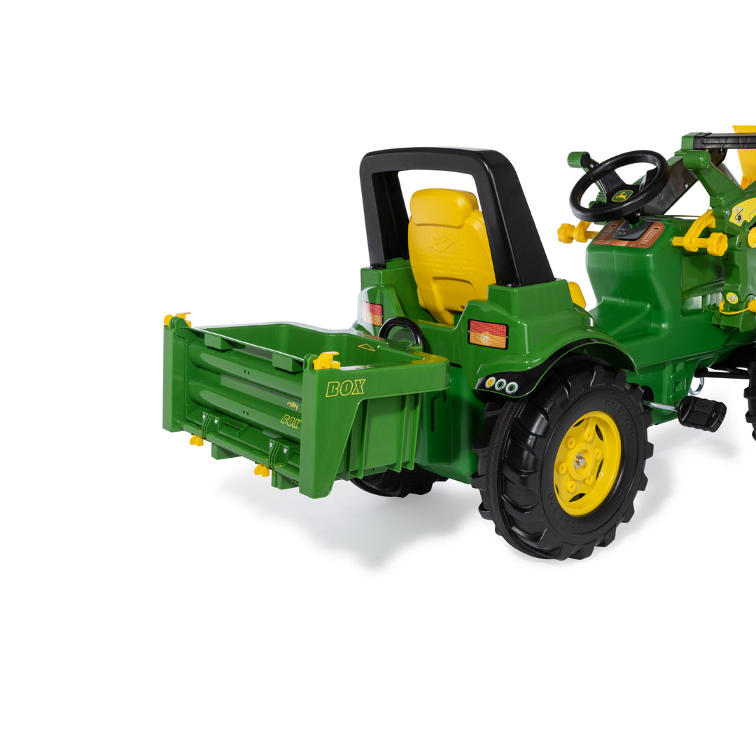 HaulBox Accessory for Tractors shown attached to green toy tractor with tiltable transport bed and detachable rear gate.