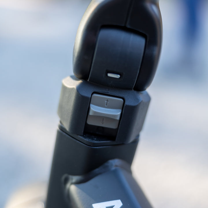 Close-up of adjustable handle mechanism on the KETTLER Air Navigator 6-in-1 Tricycle in black color.