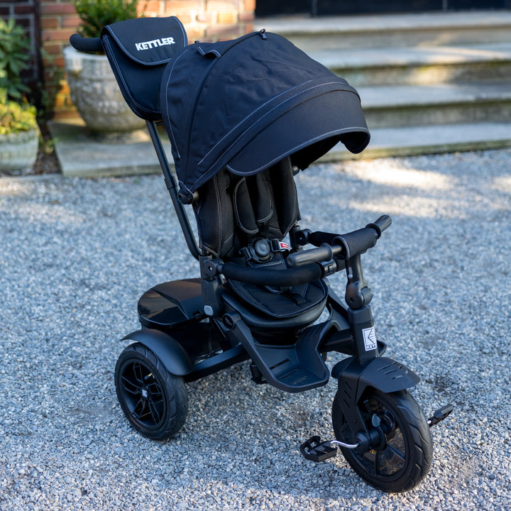 KETTLER Air Navigator 6-in-1 Tricycle black with adjustable sun canopy and safety harness for toddlers.