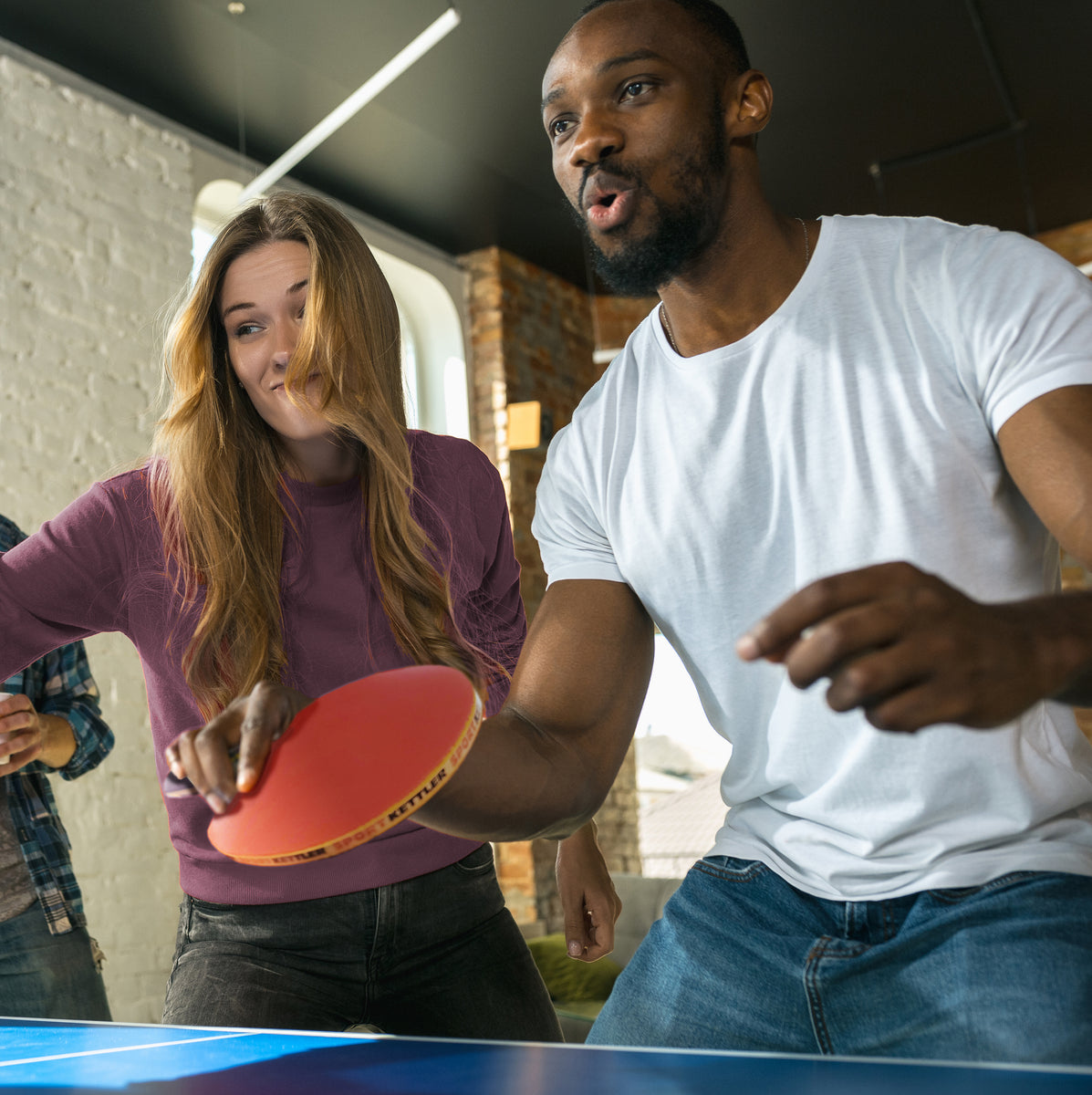 Young Adults play Table Tennis Ping Pong