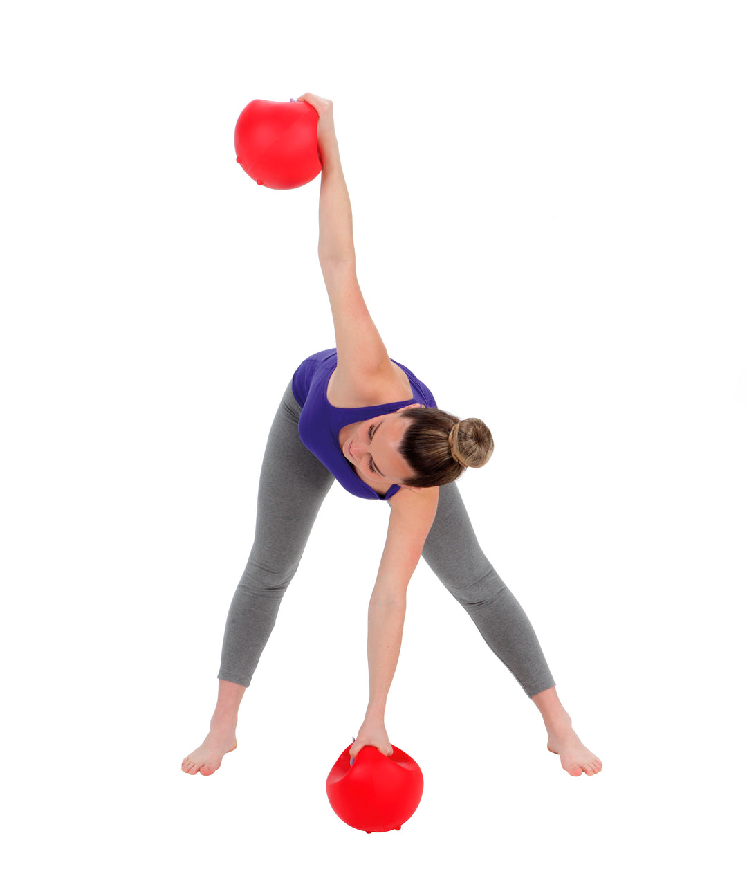 Woman exercising with red Gymnic Training Bowl Set for strength and endurance workout.
