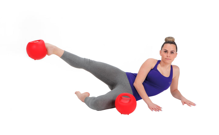 Woman exercising with red Gymnic Training Bowl Set for strength and endurance workout on white background