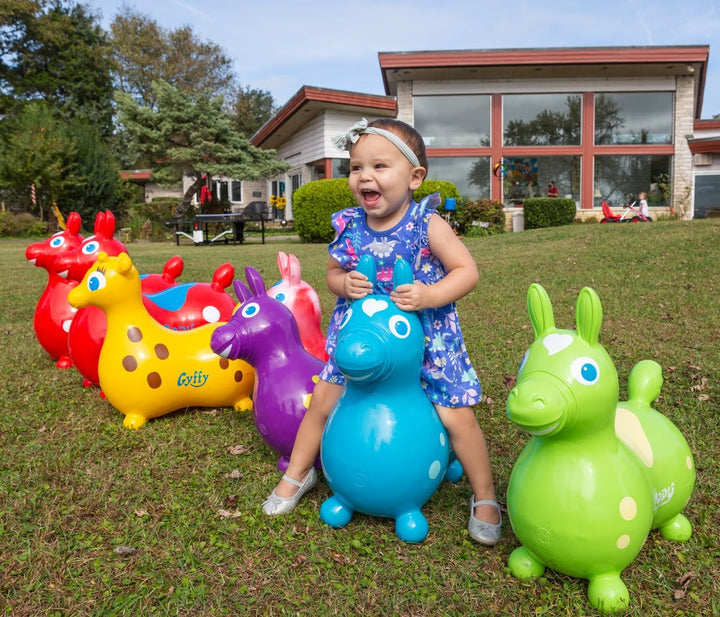 Country Playhouse & Rody Inflatable Bounce Horse Sets with colorful bounce horses and child playing outdoors on grass.