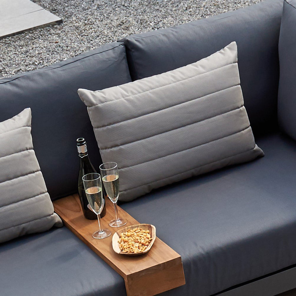 Line Pillow with textured embroidered lines in gray on outdoor couch, durable, quick drying, and weather resistant fabric.