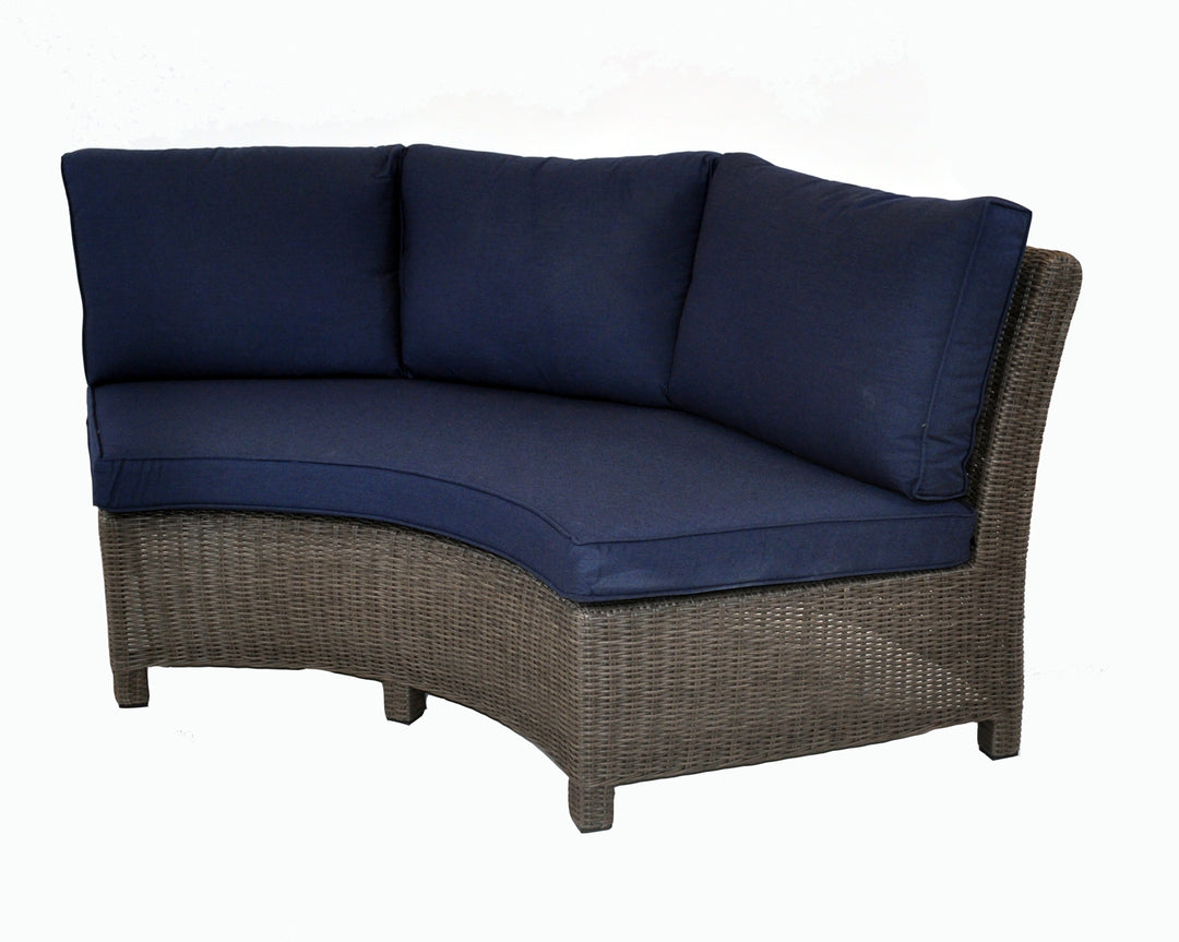 Palma Wicker Curved Sofa with handwoven weatherproof rattan wicker and navy blue Sunbrella cushions for outdoor use.