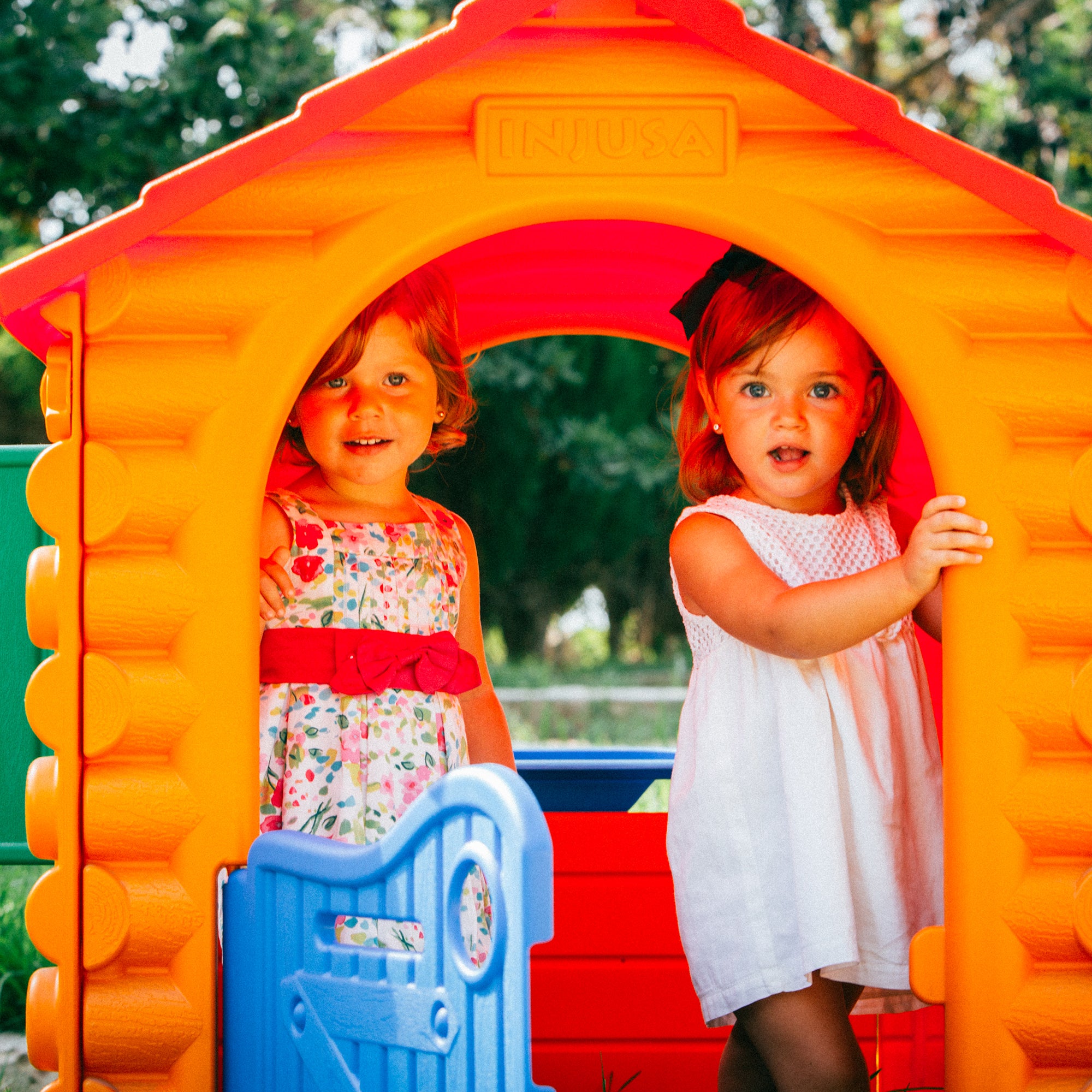 Lifestyle image of little girls playing in the INJUSA Resin Hut House.