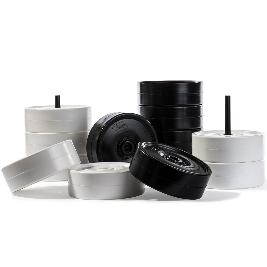 Giant Checker Pieces showing oversized black and white all weather proof playing pieces stacked with storage rods.