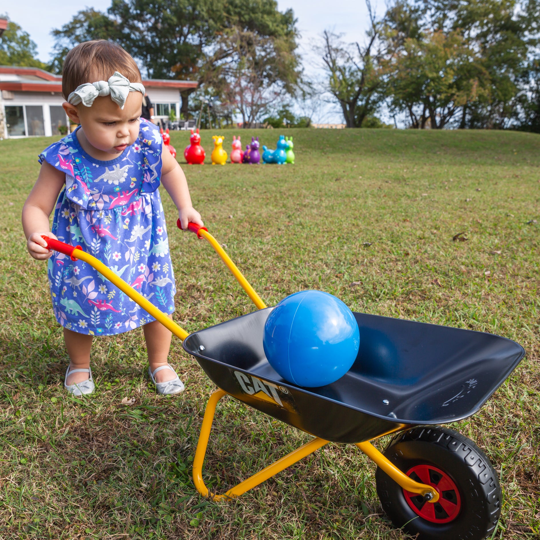 lifestyle shot of child using made in italy metal wheelbarrow 