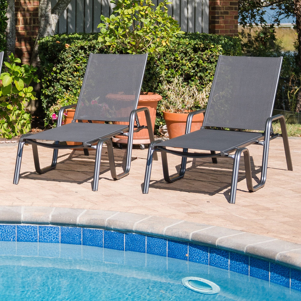 Basic Plus Stackable Loungers poolside with grey anthracite powder-coated aluminum frames and sling seats.