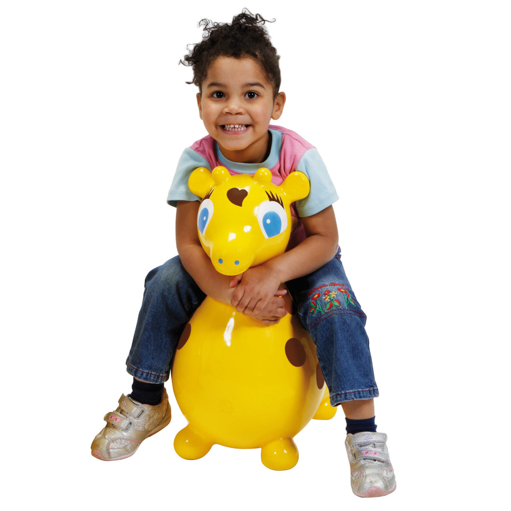Child happily sitting on bright yellow Gyffy The Giraffe Bounce Toy With Pump promoting active play.