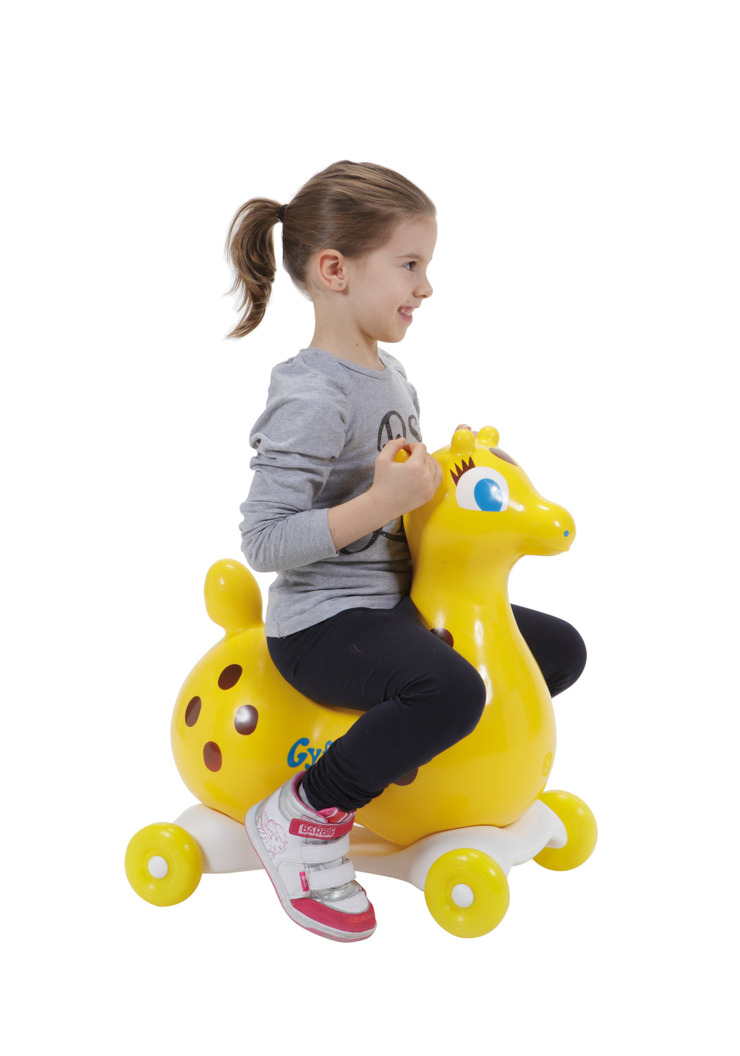 Child riding Gyffy The Giraffe Bounce Toy With Pump, a yellow inflatable giraffe on wheels promoting active play.