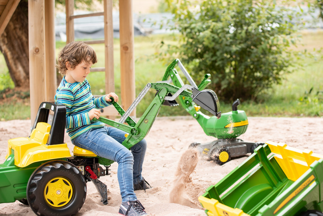 John Deere Pedal Loader With Backhoe pedal tractor with functional loader and backhoe operated by child in sandbox.