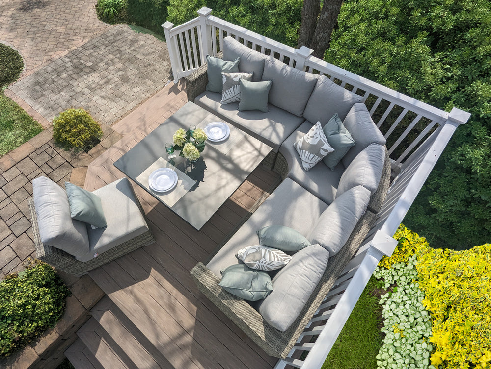 Aya Wicker 5-Piece Corner Sectional With Cushions in grey with adjustable table and outdoor setting on wood deck.