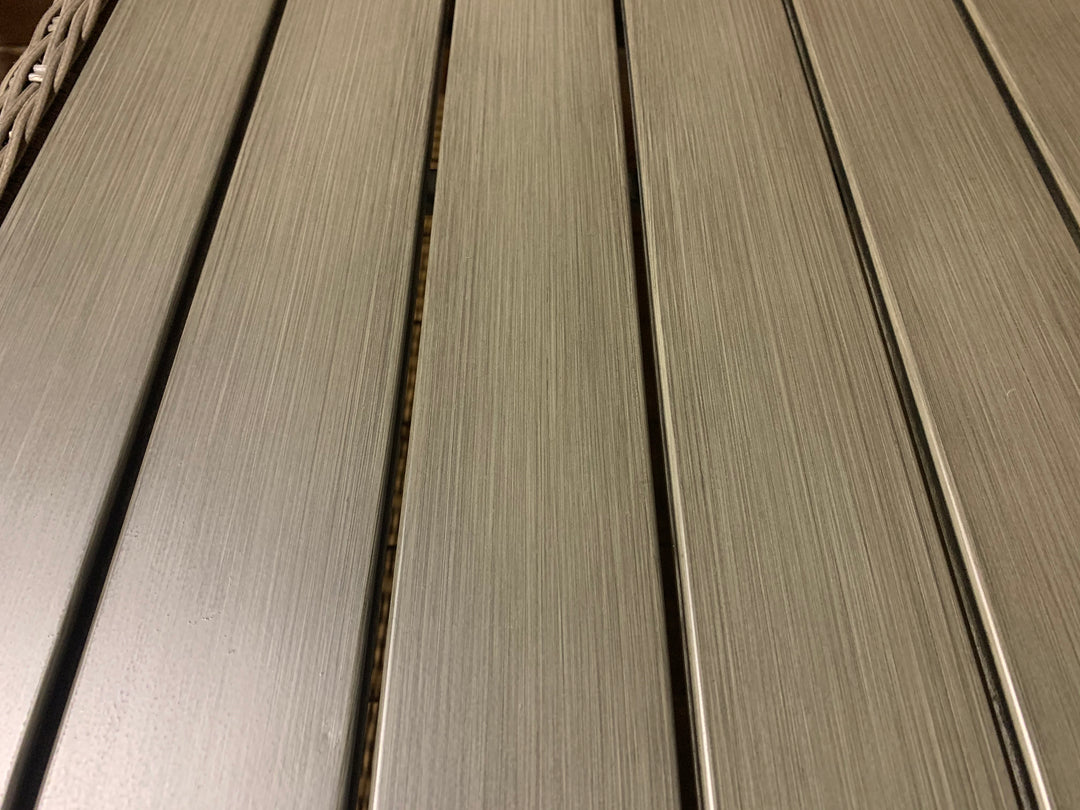 Close-up of brushed aluminum tabletop detail on Palma Wicker Side Table with weatherproof Rattan wicker frame.