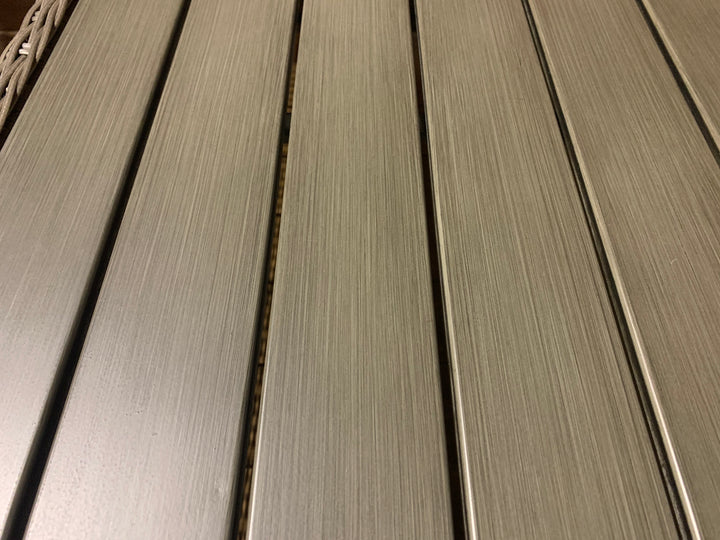 Close-up of brushed aluminum tabletop detail on Palma Wicker Side Table with weatherproof Rattan wicker frame.