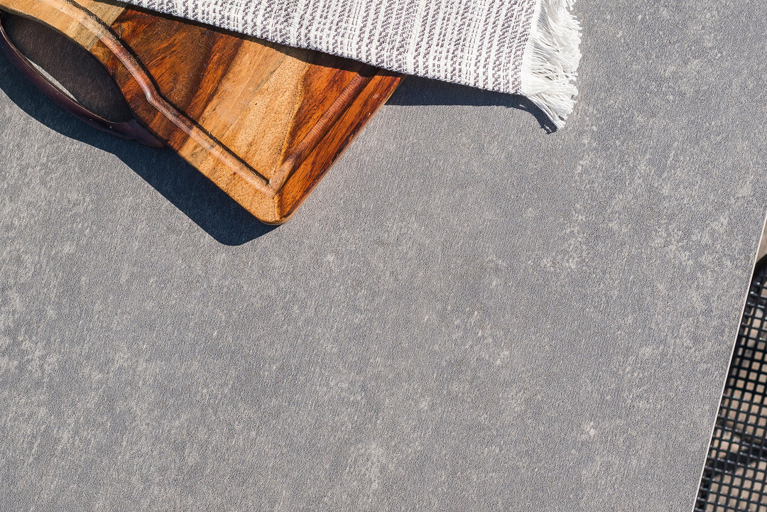 Primavera Coffee Table with concrete look ceramic top, lava aluminum frame, outdoor patio table detail close-up.