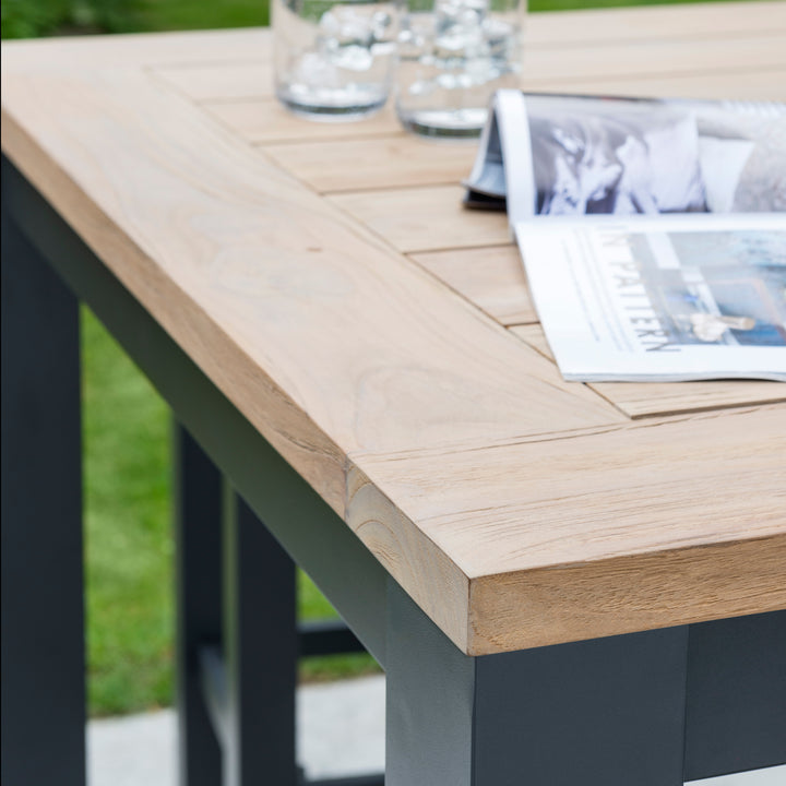 Elba Aluminum Bar Set With Teak Accents showing teak wood tabletop and charcoal aluminum frame close-up