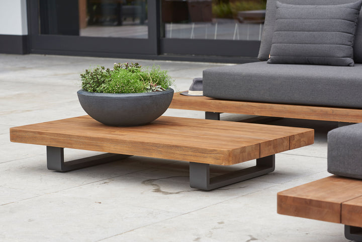 Fitz Roy Teak Corner Set with teak coffee table and gray cushions on aluminum frame outdoor patio furniture