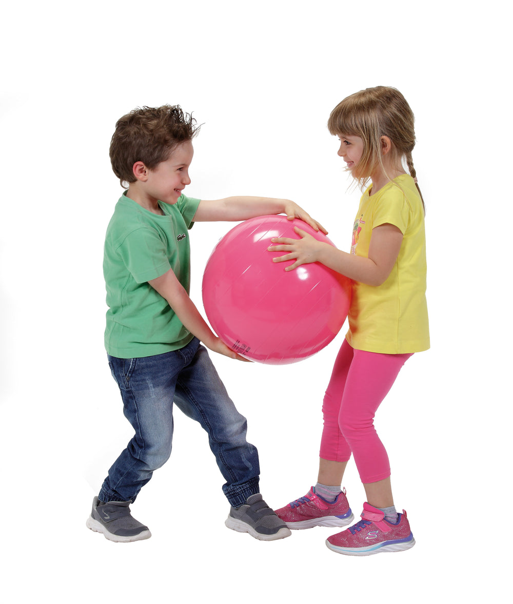 Children playing with a pink Gymnic Gym Ball designed for pediatric physiotherapy and rehabilitation exercises.