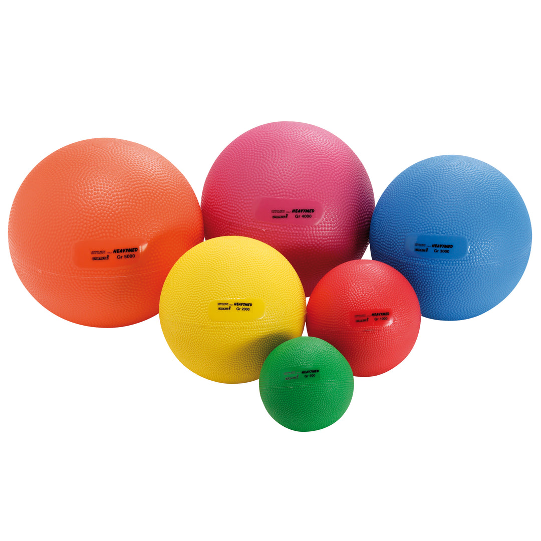Gymnic Heavymed Balls in six sizes and colors, textured for grip, designed for fitness and rehabilitation.