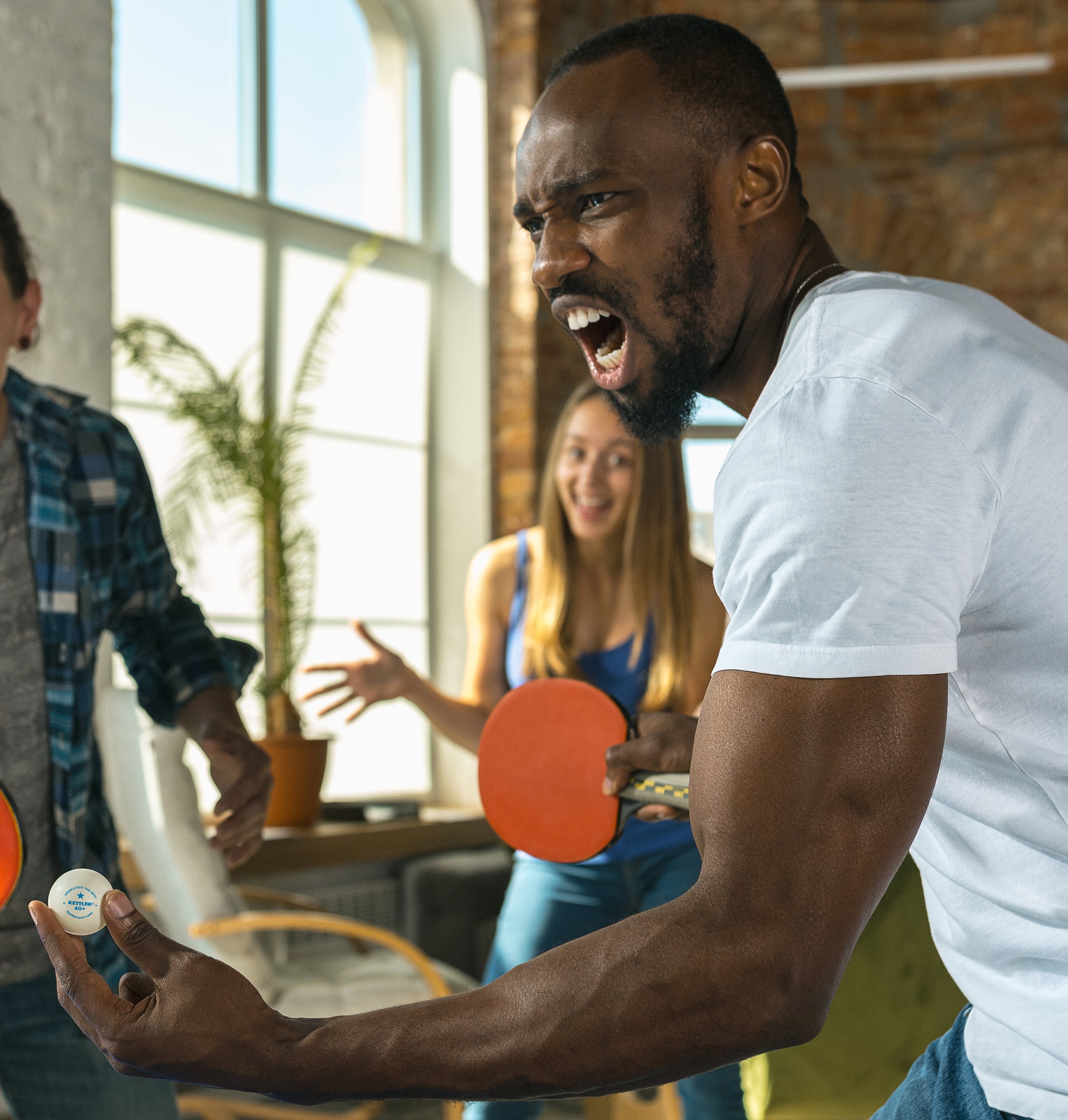 Lifestyle shot of man using 1 star table tennis training ball in white