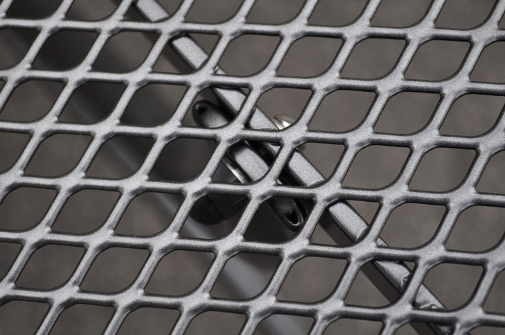 Close-up of iron grey 36-inch Square Mesh Bar Table steel mesh top with umbrella plug and Electrotherm coating finish.