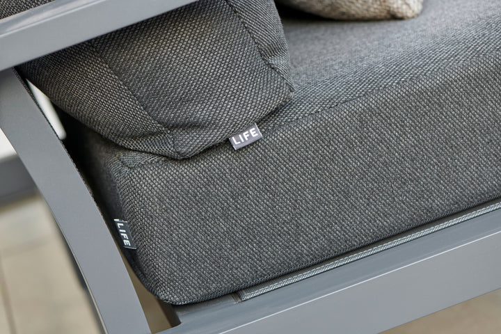 Montana Right Sofa with durable charcoal Sunbrella cushions, sturdy lava frame, and elegant teak outdoor design.