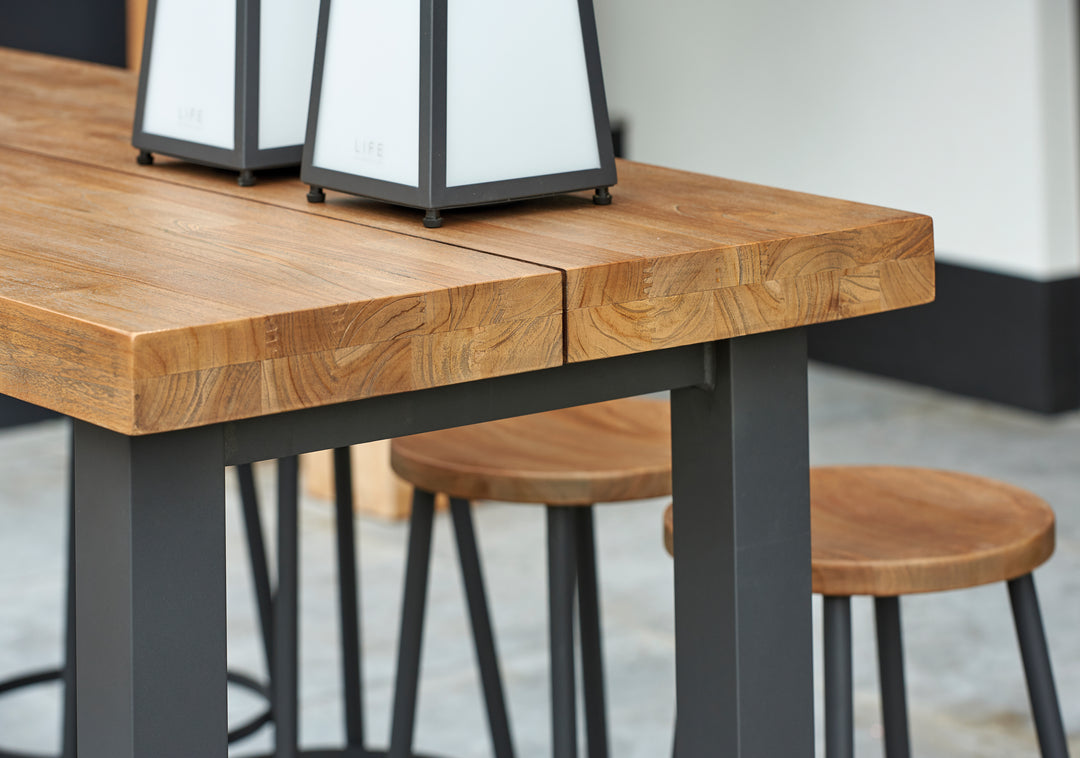 Canada Bar Height Dining Set with teak tops and durable aluminum frame in industrial design detail close-up view