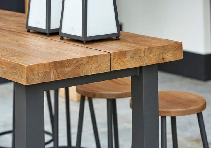 Canada Bar Height Dining Set with teak tops and durable aluminum frame in industrial design detail close-up view