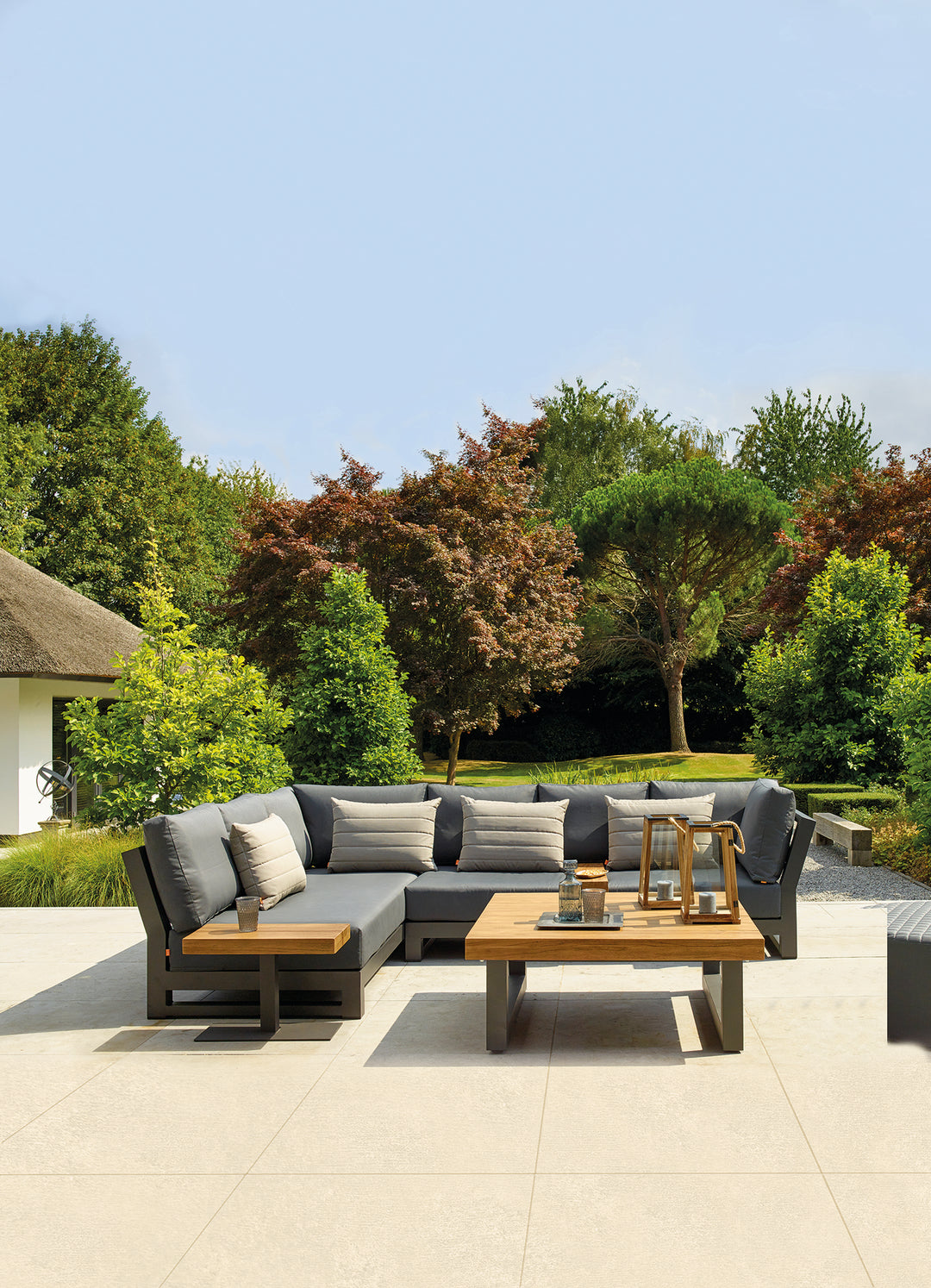 Nevada Right Sofa outdoor sectional with gray Sunbrella cushions and lava-colored aluminum frame on patio.