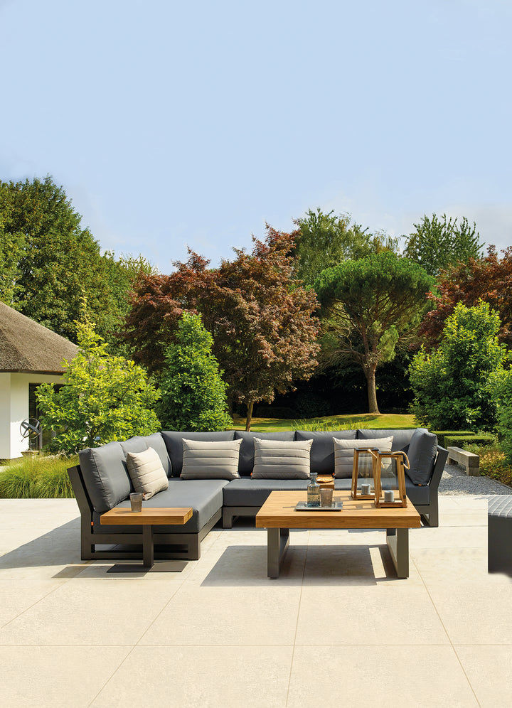 Nevada Right Sofa outdoor sectional with gray Sunbrella cushions and lava-colored aluminum frame on patio.