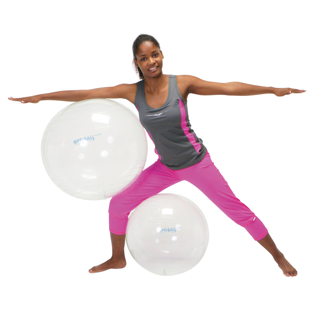 Woman exercising with transparent Gymnic Opti Ball promoting core strength and balance in fitness routine