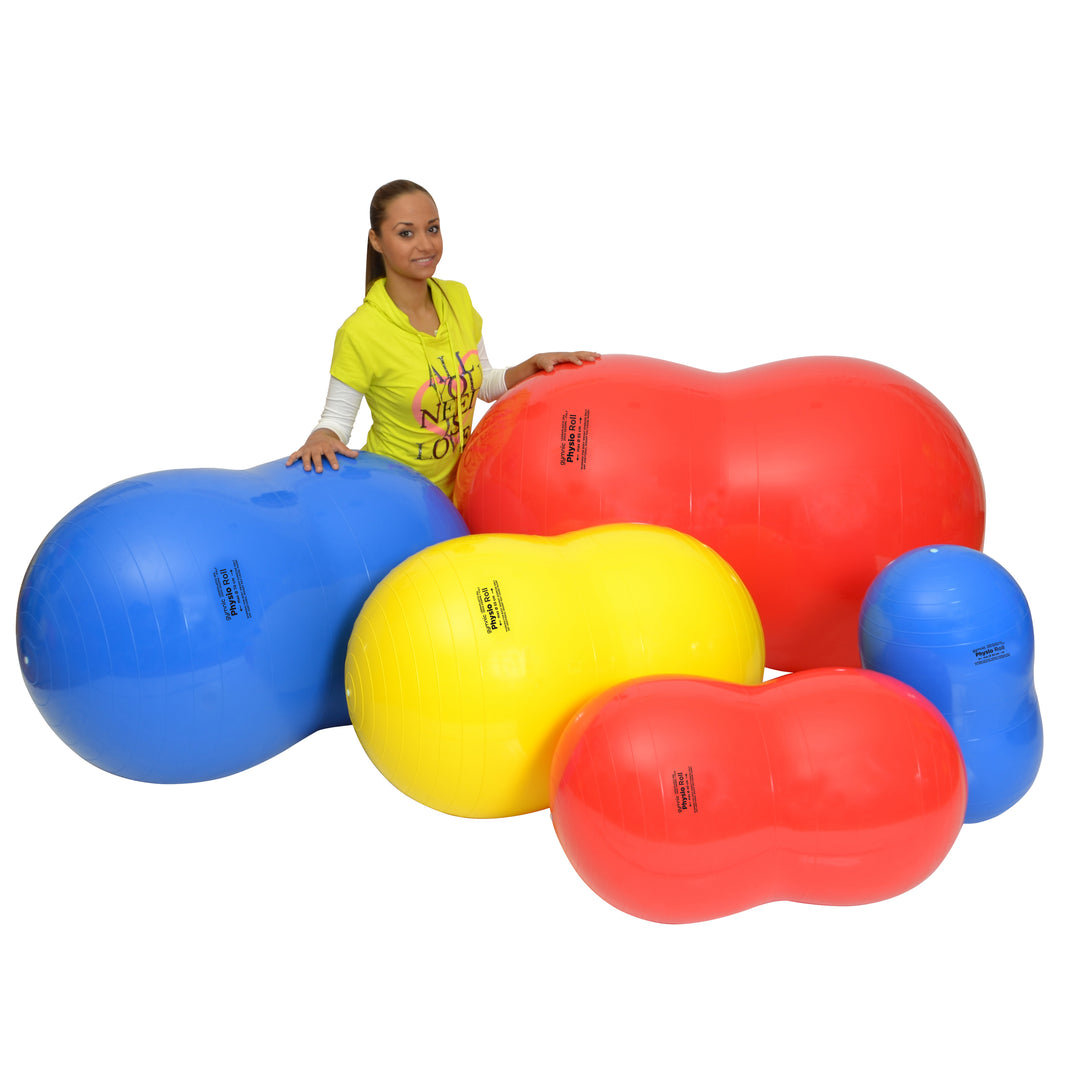 Woman with various sized Gymnic Physio Rolls in red, blue, and yellow, used for therapy and balance exercises.