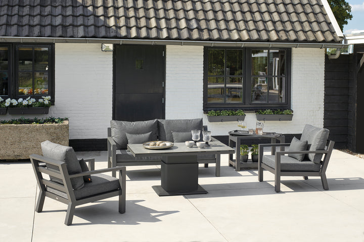 LUKA Adjustable Height Table in concrete look finish with aluminum frame in outdoor patio seating setup