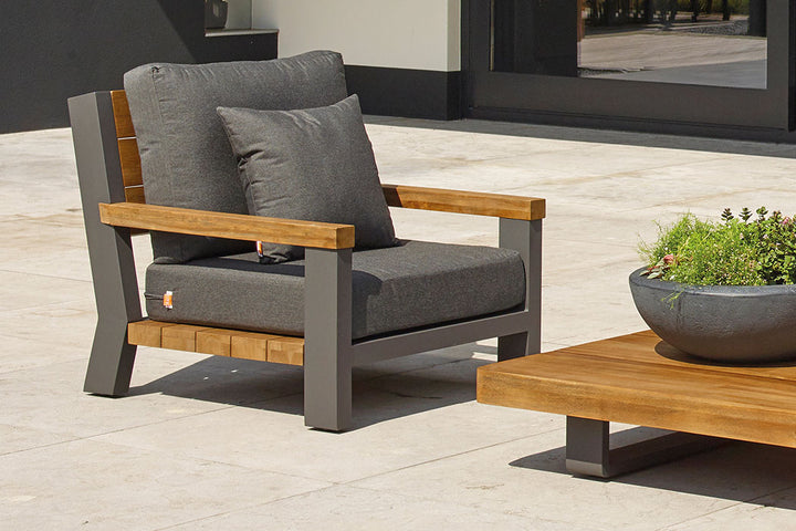 Fitz Roy Teak Corner Set outdoor chair with aluminum frame, teak accents, and all-weather charcoal cushions.